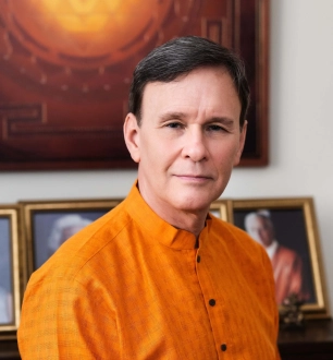 Reverend Michael Gadway wearing orange tab collared shirt.