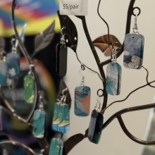 whimsical multi-colored earrings on an earring tree