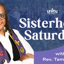 Rev Tami Johns wearing white blouse, purple interfait prayer shawl. crowd of women in backgroud with words Sisterhood Saturday, Unity of the Triangle logo
