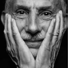 Author Jack Kornfield extreme closeup face in hands in black and white