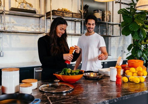 young couple cooking healthy food as part of holistic health