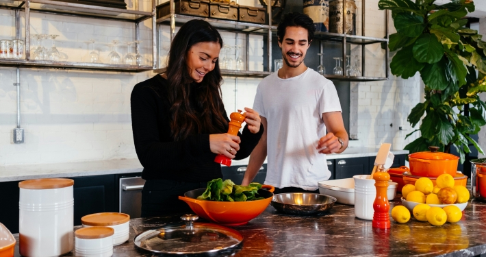 young couple cooking healthy food as part of holistic health